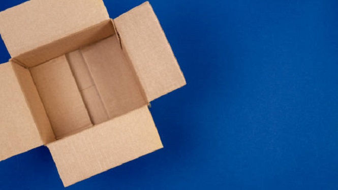 Open empty cardboard boxes on blue background.